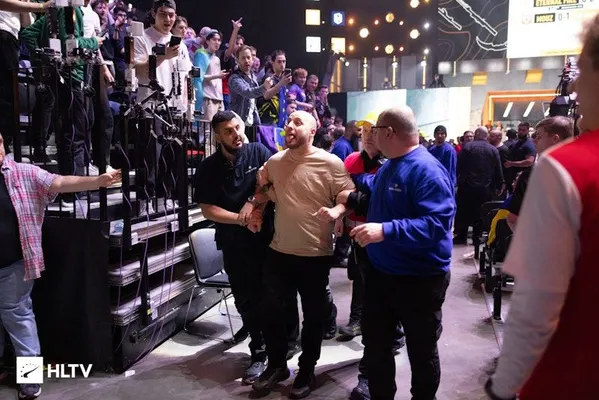 An audience member being taken away from the Royal Arena by security